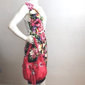 Michael Kors bold red bucket bag with large grommet, braid straps and  tassels.